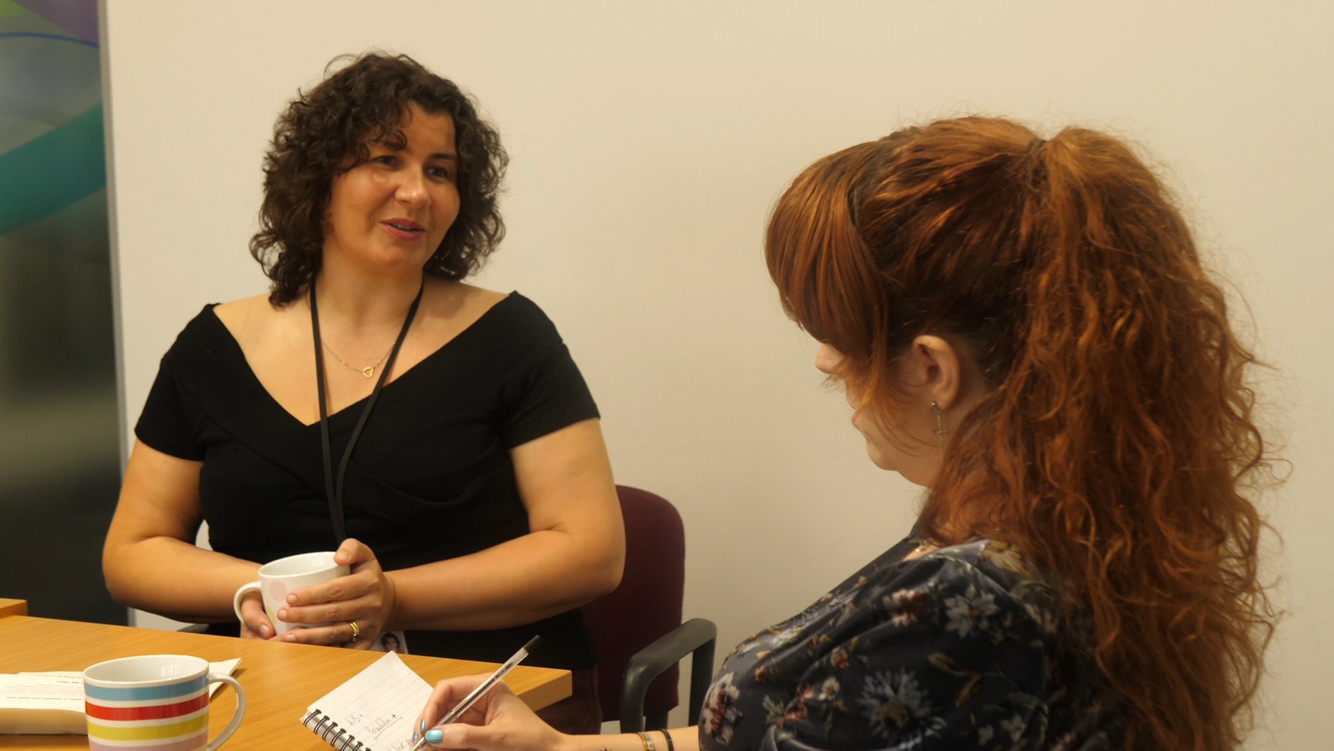 ali, a social work student, and sybil, practice educator, having a professional discussion