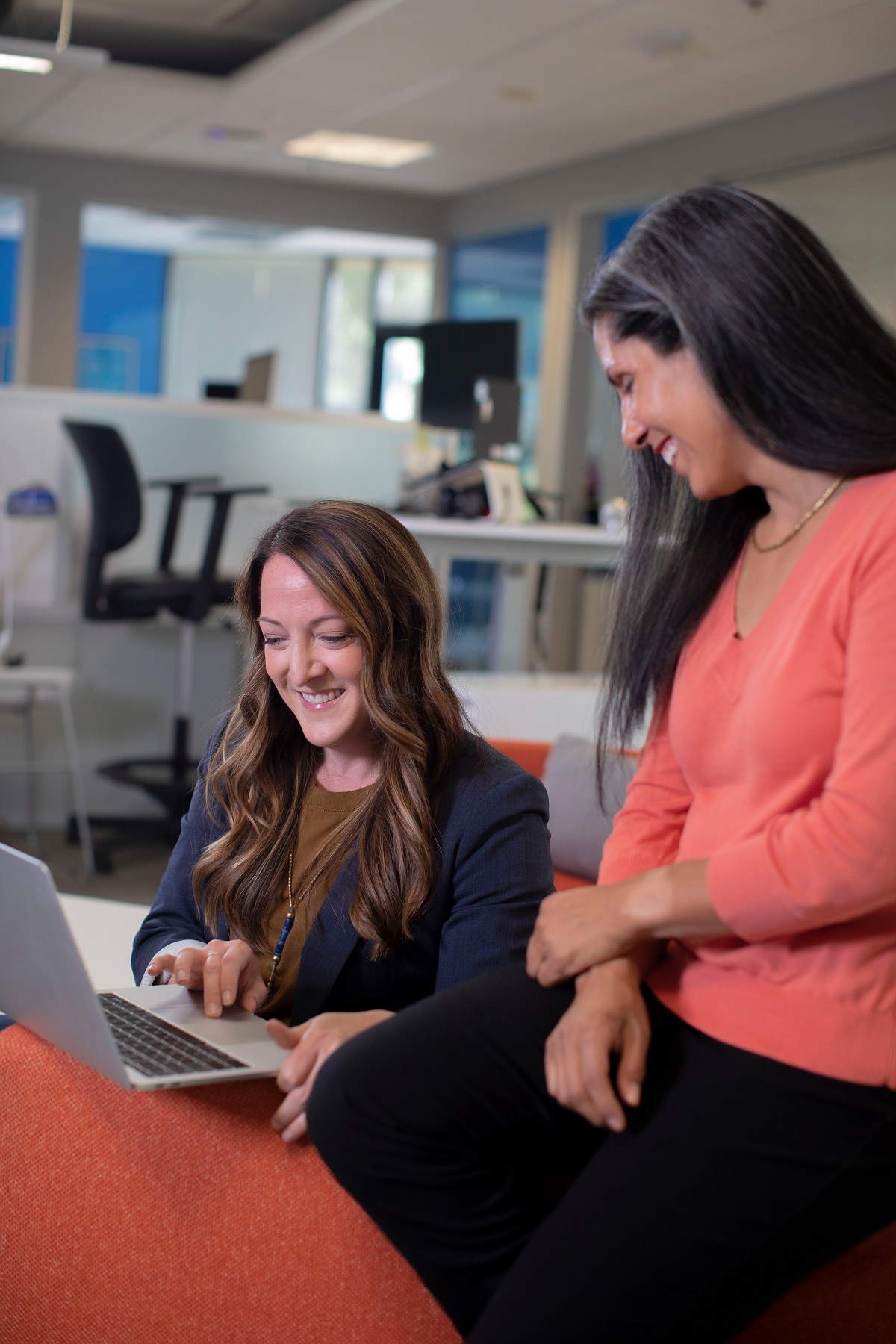 Two women using a laptop