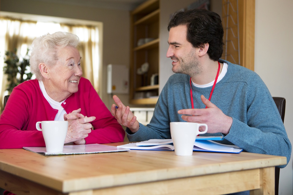 Man coversing with elderly woman.