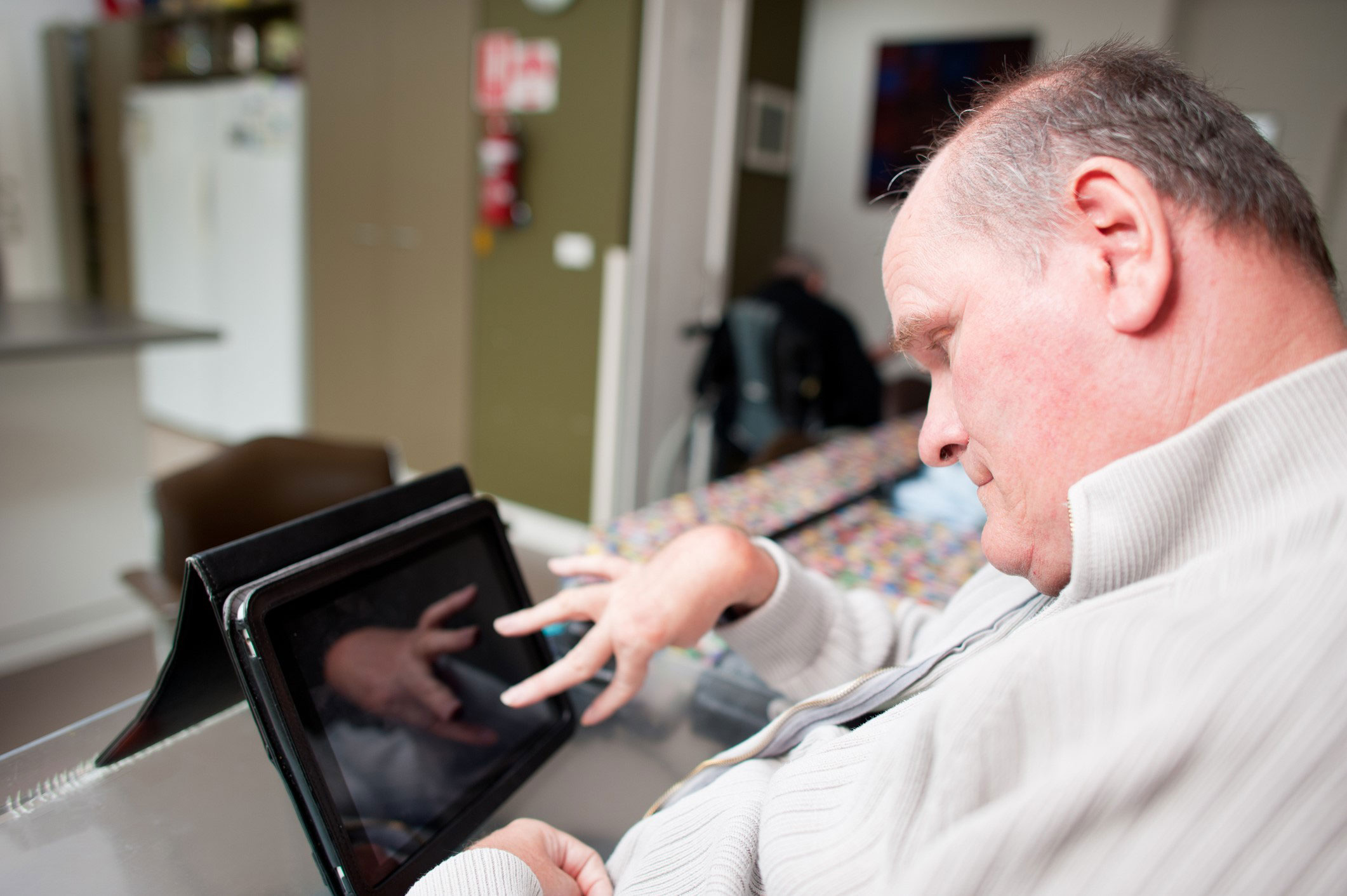 Man using social media on his tablet.