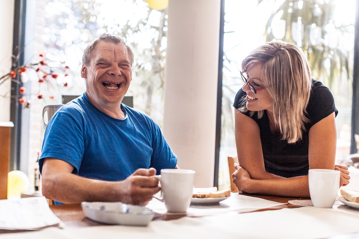 Man laughing with woman.